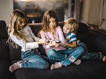 siblings fighting over a remote